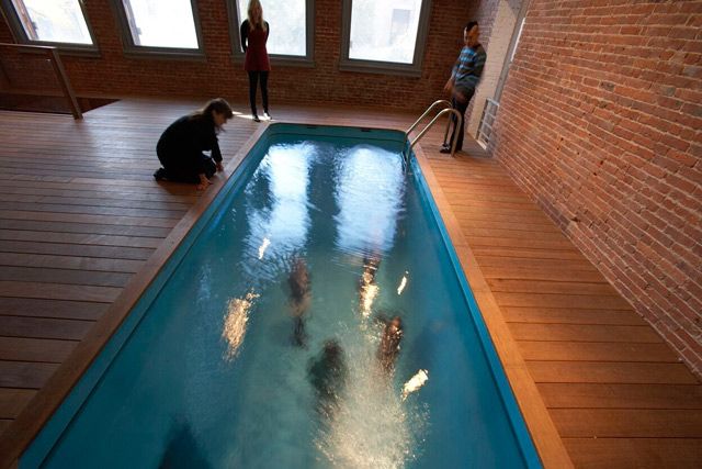 Leandro Erlich: Swimming Pool is a year-long installation that debuted inside P.S. 1 in October. Seen from the deck-level, it looks like an ordinary swimming pool, and one's inclined to walk by thinking, "Ugh, typical conceptual bullshit." BUT this swimming pool is actually a mirage, with a shallow glass bottom above a basement room, where visitors can descend and gaze up through the water. It's the perfect place to sit in your Budweiser swim trunks, sip a whiskey, and brood.